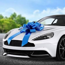 A new car decorated with a large bow as a birthday gift