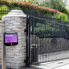A gated entrance leading into a private residential community.