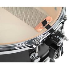 A snare drum with its metal wires visible beneath the drumhead.
