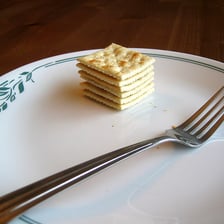 Square saltine crackers on a plate