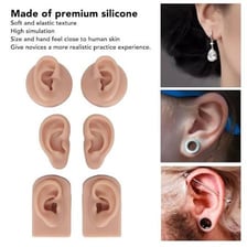 A human ear with a piercing and an earplug