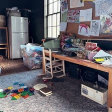 A cluttered room with belongings scattered around
