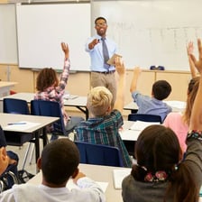 Teacher instructing students preparing for an exam