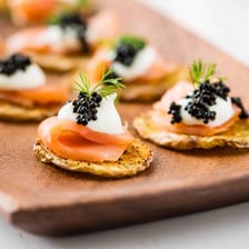 Small canapés garnished with orange fish roe.