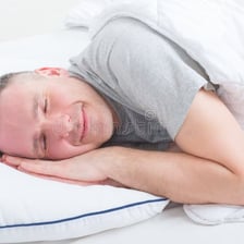 A person peacefully sleeping in bed.