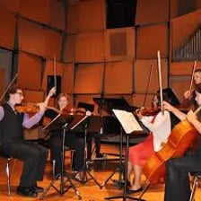 Cellos being played in a chamber music ensemble.