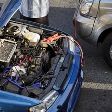 A race car waiting at a starting light with its engine running.