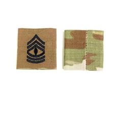 A corporal’s rank insignia displayed on a military uniform.
