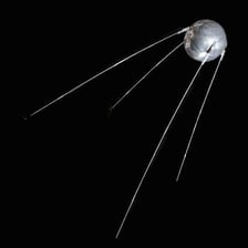 A replica of Sputnik 1, a spherical satellite with antennae.