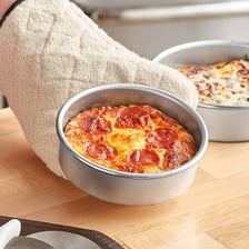 A deep-dish pizza baked in a round pan