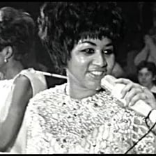Aretha Franklin performing onstage.