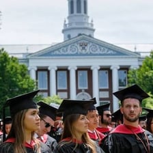 Graduates at a business school commencement ceremony.