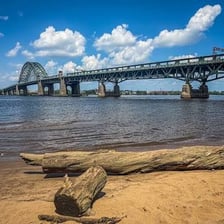 A bridge extending across a river between two shores.