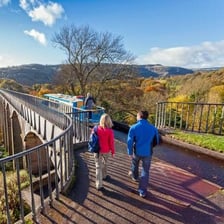 People in Wales with a Welsh landscape in the background