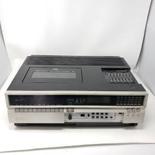 A vintage VCR with a VHS cassette