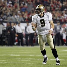 A football quarterback celebrating after throwing a touchdown pass.