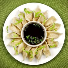 Chinese dumplings arranged on a plate.