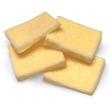 A small square pat of butter on a plate
