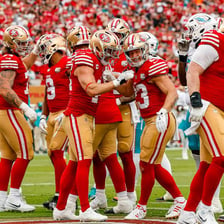 San Francisco 49ers players wearing their red and gold uniforms.