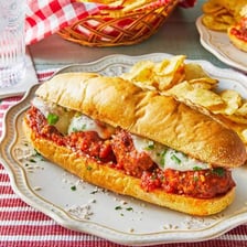 A meatball sub filled with meatballs, marinara sauce, and cheese.