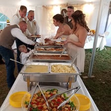 A caterer serving food at a wedding reception