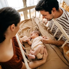 A parent arranging a nursery in preparation for a new baby.