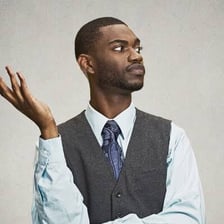 A person making an annoyed dismissive gesture