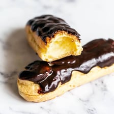 A chocolate-glazed éclair filled with cream.