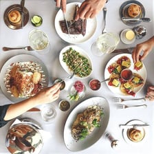People gathered around a table ready to eat dinner