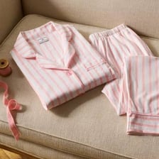 A pair of pajamas folded on a bed.