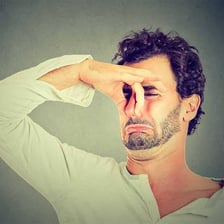 A person reacting to an unpleasant odor.