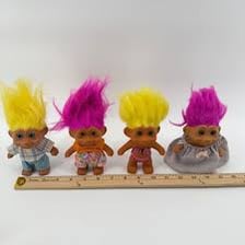 A troll doll with brightly colored upright hair.