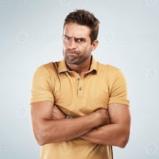 A person with crossed arms and an openly hostile expression