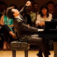 A musician performing alone during a recital.
