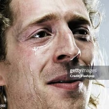 A close-up of a person crying with visible tears.