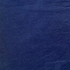 Blue denim fabric showing its woven texture.