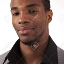 A person wearing a knowing, sly expression.