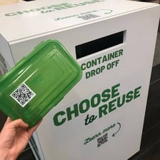 A reusable container being used again instead of discarded.
