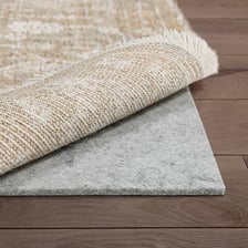 A rectangular mat lying on a floor.