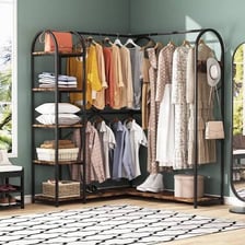 An open closet filled with hanging clothes