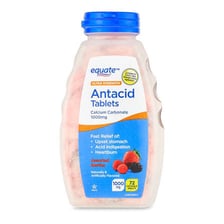 A bottle and tablets of antacid medicine