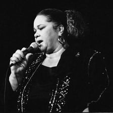 A photograph of blues singer Etta James performing.