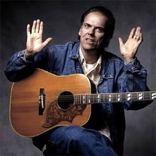 Singer-songwriter John Hiatt performing with a guitar