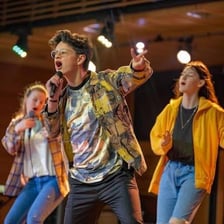 A skilled performer appearing on a theater stage.