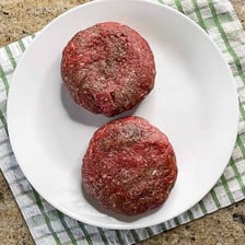 A round patty made from ground beef