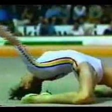 Nadia Comăneci performing a gymnastics routine.