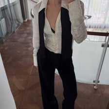 A person checking the fit of clothing in a mirror