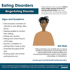 A person sitting before a large meal and eating heavily.
