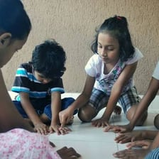 Children using a counting-out rhyme while choosing who will be “it”