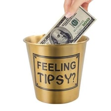 One-dollar bills placed in a tip jar.